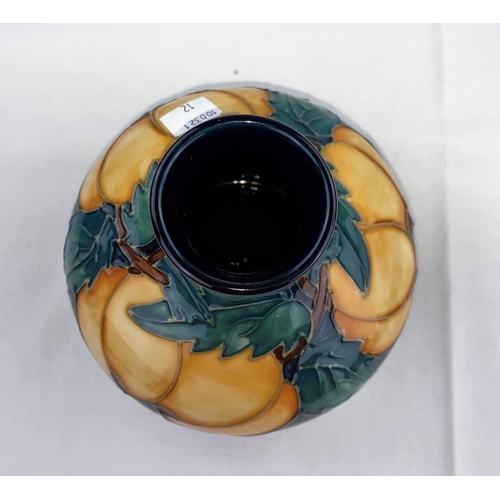12 - A squat circular Moorcroft vase decorated with apricot type fruit & green leaves impressed diameter ... 