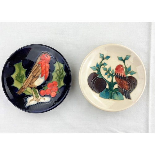 21 - 2 Moorcroft pin dishes one decorated with robin on holly twig, the other with a bird, leaves & plums... 