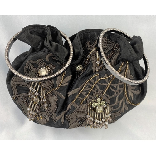 241 - A Karen Millen evening handbag with twin circle diamante handles, tube line body decoration with app... 