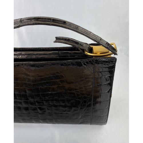 242 - An apricot patent clutch bag, a blue leather wallet, black patent 'crocodile' handbag (handle broken... 