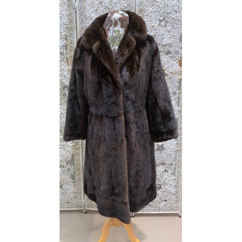 247 - A  full length brown mink coat with belt; a vintage musquash coat and another