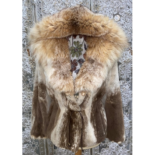 249 - A late 20th century fur coat with drawstring waist and fur lined hood, M