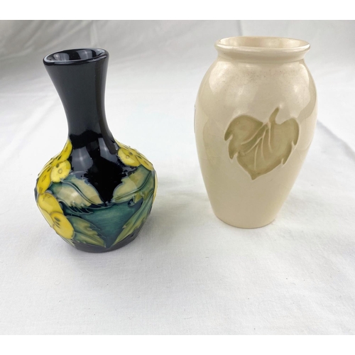 28 - A small bulbous slender neck Moorcroft vase decorated with primroses, impressed & monogrammed height... 