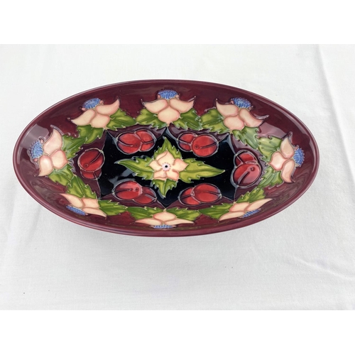 29 - An oval Moorcroft dish decorated with pink flowers & fruit impressed & monogrammed length 23.5cm