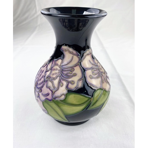 33 - A bulbous Moorcroft vase with flared rim decorated with lilac coloured flowers & green leaves  impre... 