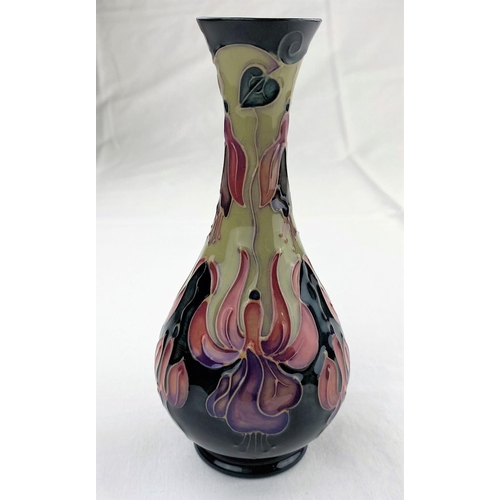 35 - A Moorcroft baluster slender neck vase decorated with stylized flowers in purple, red & green impres... 