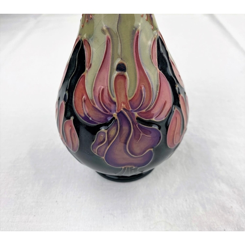 35 - A Moorcroft baluster slender neck vase decorated with stylized flowers in purple, red & green impres... 