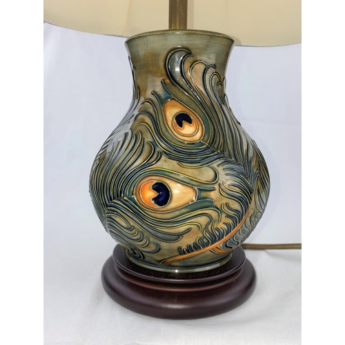 44 - A Moorcroft baluster table lamp decorated with peacock feathers with shade height of base 19cm