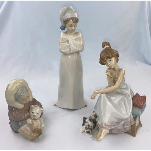 55 - Three Lladro figures - girl in nightcap, Eskimo girl with bear, girl on the telephone (receiver a.f.... 