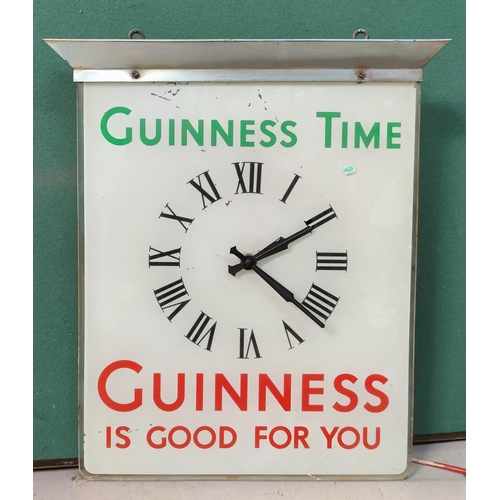 123 - A Guinness swinging clock/advertising poster height 54cm