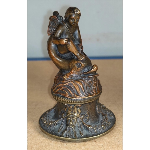 136 - An 18th century European bronze cherub riding a dolphin on bell shaped base height 9cm