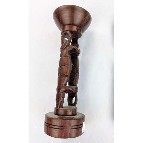 168 - An African tribal carved wood figure 22cm; a hardwood candle holder 20cm
