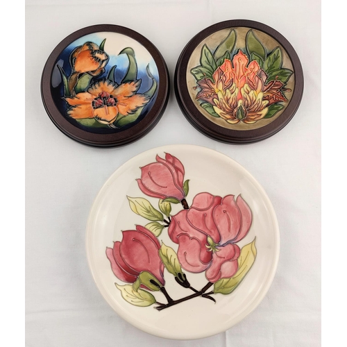 6 - A Moorcroft Magnolia plate diameter 26cm; 2 Moorcroft plates decorated with flower heads diameter 16... 