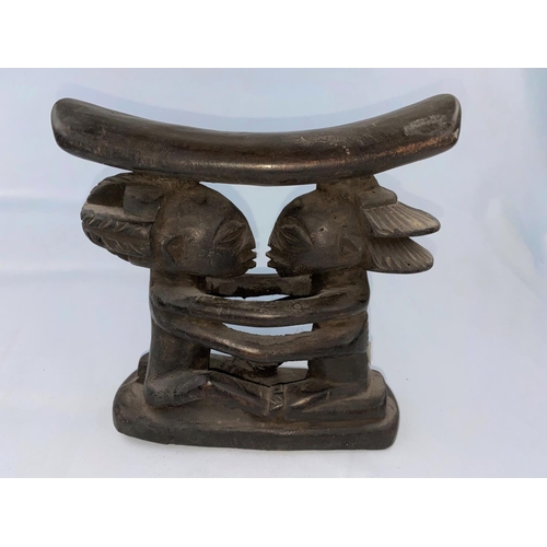 164 - A Central African Luba tribal carved wood neck rest, the support in the form of embracing figures, t... 