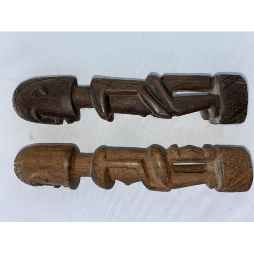 166 - A pair of African tribal carved wood figures, male and female 19cm