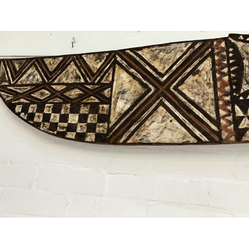 184 - An East African tribal carved wood hawk mask, Bwa shallow carved geometric decoration painted in ear... 