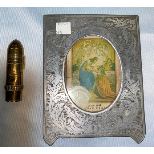 374 - A Trench Art cigarette lighter in the form of a small shell & a similar aluminium photo frame inscri... 