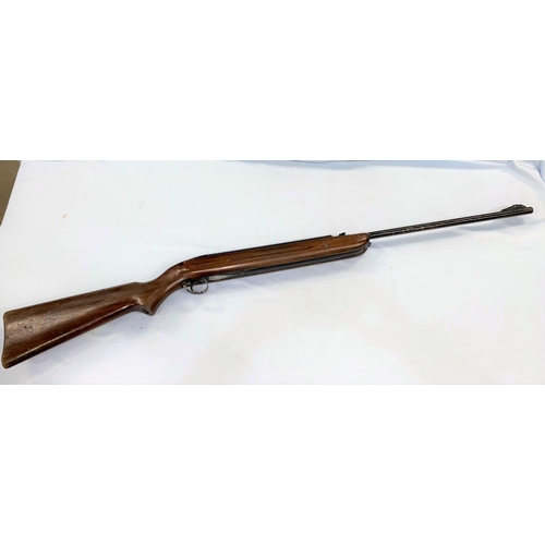 385 - An air rifle with wooden stock stamped GT41055 (stock needs tightening, loading area with damage)