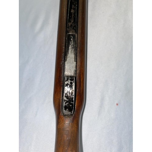 385 - An air rifle with wooden stock stamped GT41055 (stock needs tightening, loading area with damage)