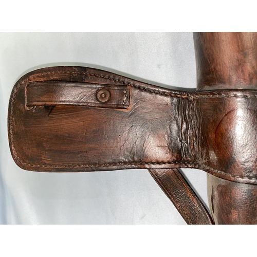 391 - A leather 'bucket' holster for horse back riding, with buckle, length 83cm