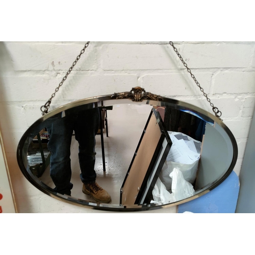 218B - A silvered framed oval mirror
