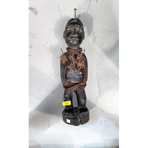 173 - An African tribal carved wood fetish figure, applied nails and fibre rope, split at base 47cm