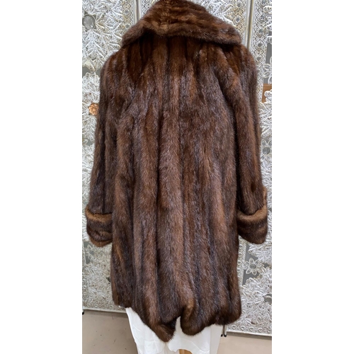 245 - A vintage three quarter length brown A line mink coat with turn back cuffs
