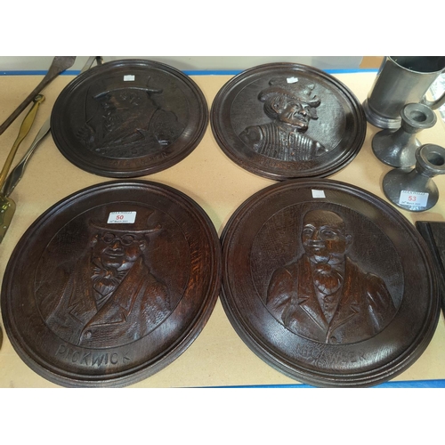 50 - A carved oak set of 4 roundels depicting Dickens characters