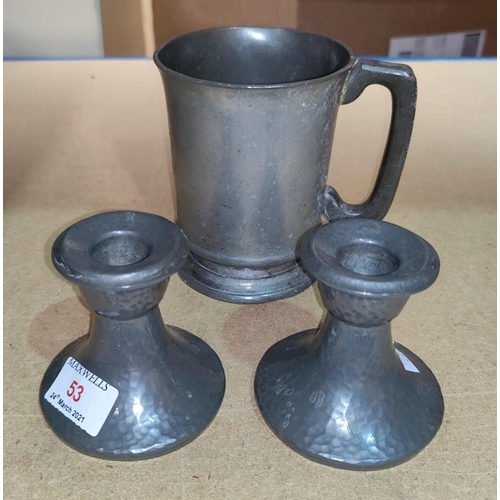53 - A pair of Tudric dwarf candlesticks in planished pewter, 01417; a pewter 1 pint mug