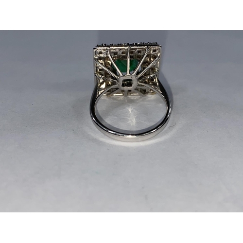 360 - A white metal Art Deco style ring set square emerald surrounded by clear stones, tests as 14 ct, 8.5... 