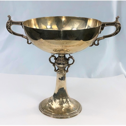 386 - A hallmarked silver trophy bowl, 2 handles and pedestal base with ornate relief decoration, inscribe... 