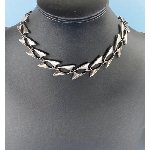 294 - Georg Jensen, a silver necklace designed by Henning Koppel formed from double fin shaped pierced lin... 