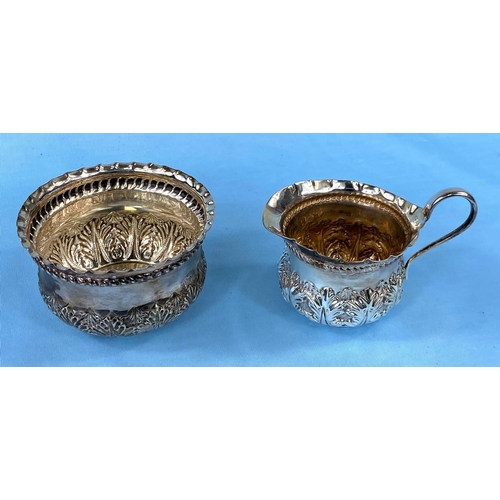 302 - A hallmarked silver sugar & cream set with extensive embossed decoration, London 1889, 3.5oz