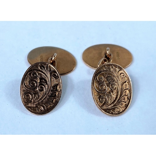 324 - A pair of 9ct gold oval cufflinks with naturalistic designs, makers mark JC 4.5gms