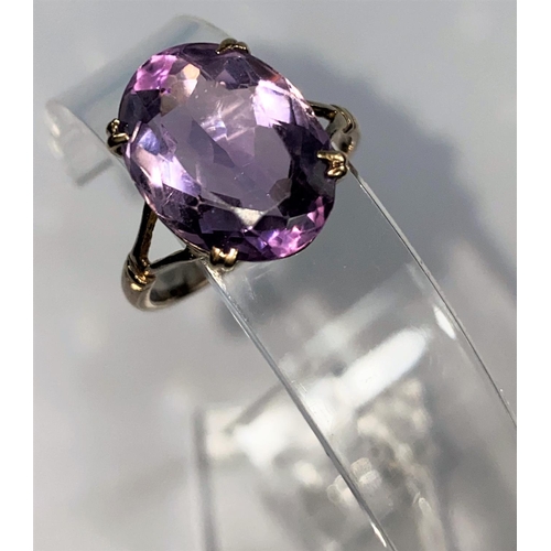 362 - A 9 carat gold dress ring set large amethyst coloured stone, 4.8 gm. size R.5