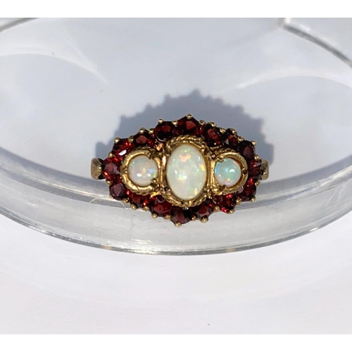 368 - A vintage 9ct hallmarked dress ring set with 3 opals surrounded by 16 garnets size Q 5.7gms