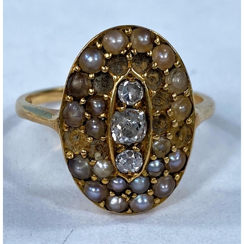 418 - An Edwardian yellow metal dress ring set with 3 central old cut diamonds surrounded by 2 rows of see... 