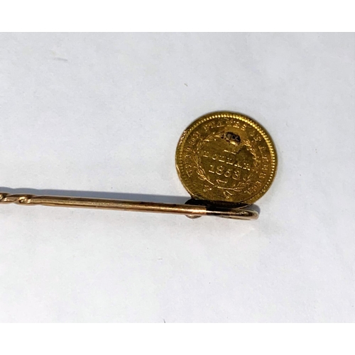 440 - A miniature USA 1853 gold one dollar coin on a yellow metal pin (tests approx 9ct) gross 2.7gm