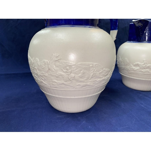 165 - A graduating set of 5 19th century Parian ware jugs decorated with hunting scenes in relief (possibl... 
