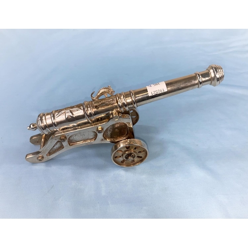 395A - A small silver plated cannon on stand bearing the Maltese Cross length 23cm