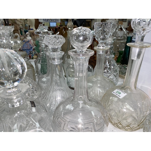 239 - A collection of cut decanters, 17 approx (some stoppers matched; some chips)