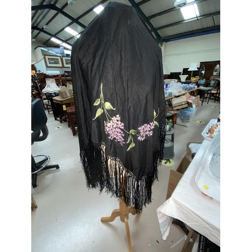 35 - Two embroidered fringed black shawls in the Madeira style; 3 other shawls (some damage / holes0
