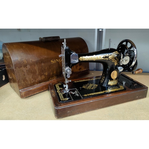 12 - An early 20th century hand operated sewing machine in walnut case