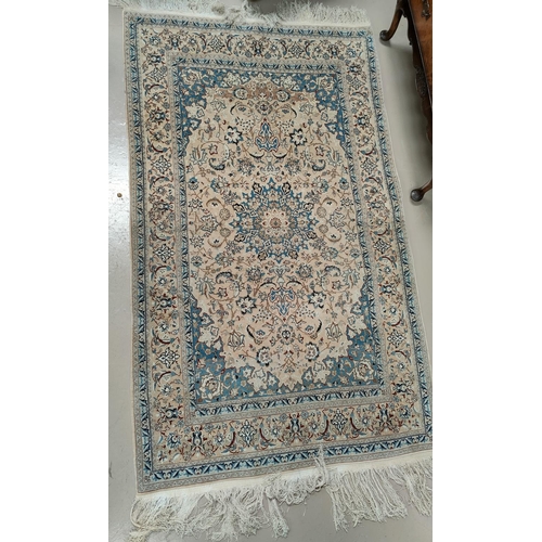 496 - A 20th century hand knotted fawn ground middle eastern carpet 180cm x 109cm