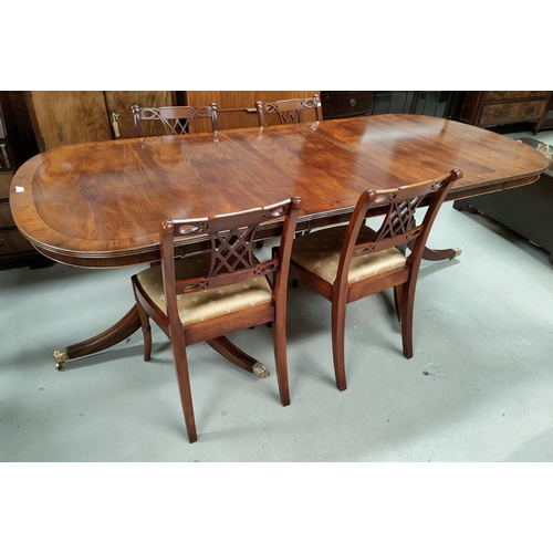 533 - A reproduction Regency mahogany dining suite with wide yew-wood cross banding comprising extending t... 