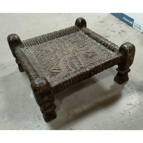 54 - An Indian carved hardwood and woven leather plant seat 39cm