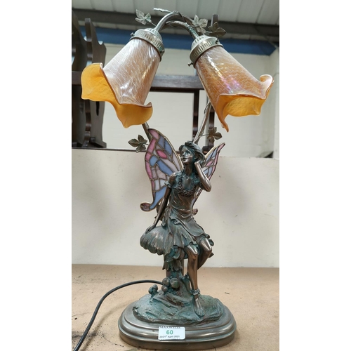 60 - A bronzed effect table  lamp depicting a fairy sat on a mushroom with Tiffany style wings, trio lust... 