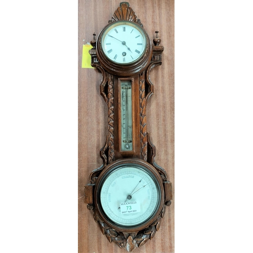 73 - An Edwardian clock/barometer with thermometer in carved oak wall hanging case