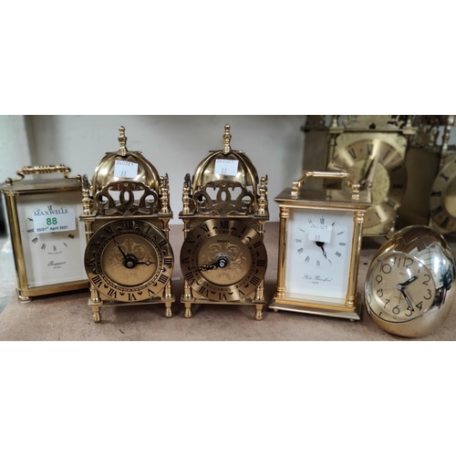 88 - Two reproduction lantern clocks and 2 reproduction carriage clocks with battery movements; an 'egg' ... 