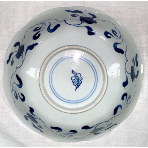 189 - A Chinese blue and white dish with ribbed, scalloped border decorated with panels of flowers and tra... 
